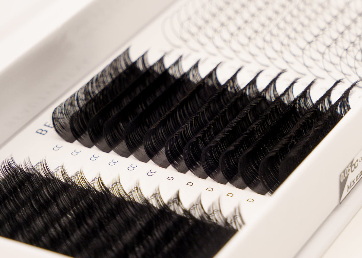 Set of false eyelashes in a white tray on a white background